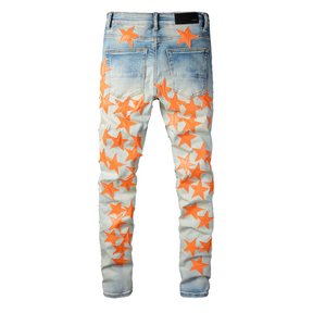 Amiri Slim Fit Designer Jeans mit Orangefarbenen Stern-Patches für Herren